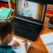 Distance learning online education. A schoolboy boy studies at home and does school homework. A home distance learning