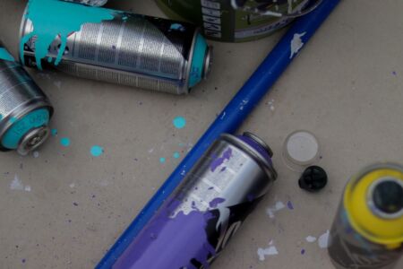 Four cans of graffiti on a table
